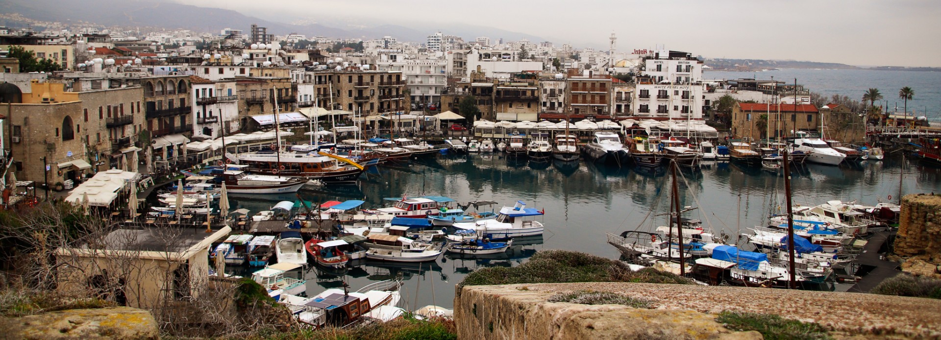 Vy från borgen över Kyrenias hamn med regntunga moln